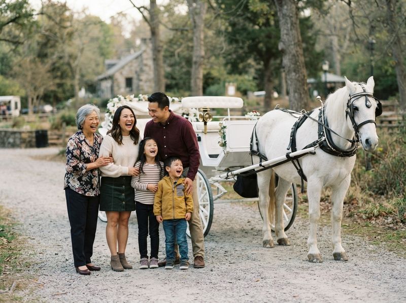 Three generations of a family beside a carriage and white horse